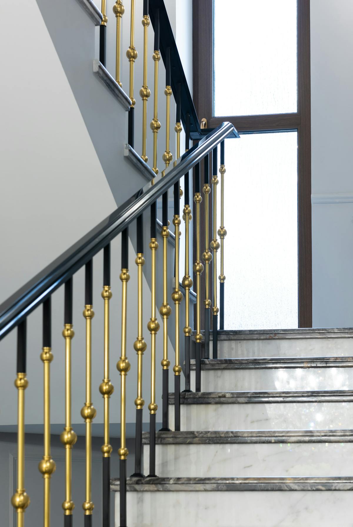 Elegante Treppe mit Metallgeländer und Marmorstufen
